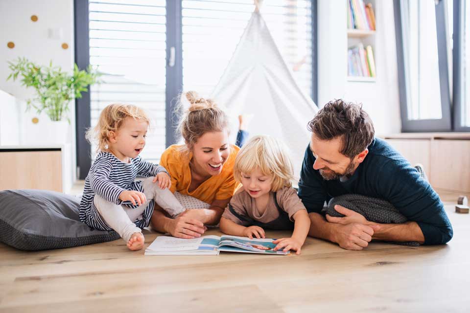 family spending floor time reading a book